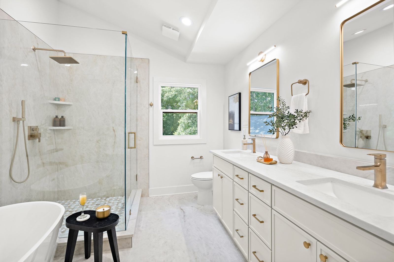 Completed bathroom renovation with a walk-in shower, soaking tub, and double vanity
